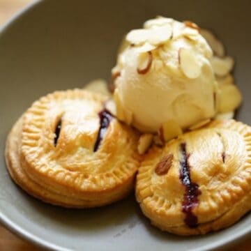 Air Fryer Blueberry Handpies in a gray bowl with ice cream