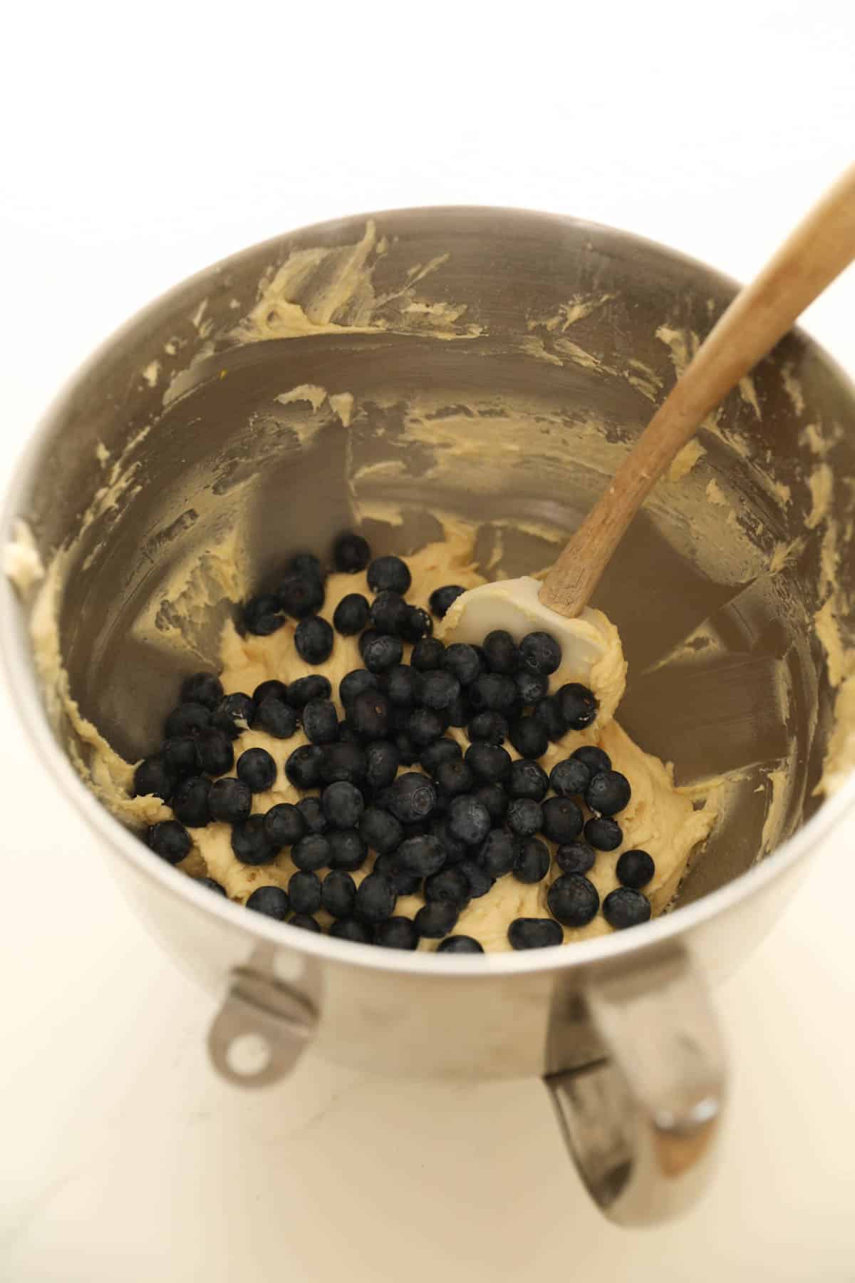 a bowl of batter with blueberries on top