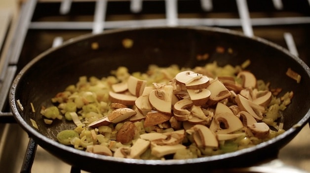 Mushrooms and leeks cooking in a non-stick skillet