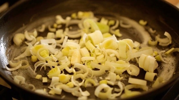 leeks cooking in butter in a non stick skillet