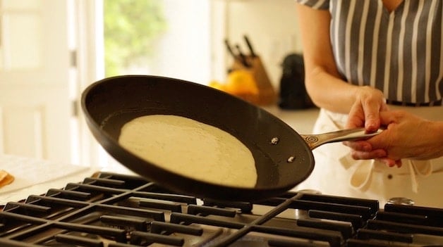 Swirling pan around to distribute crepe batter