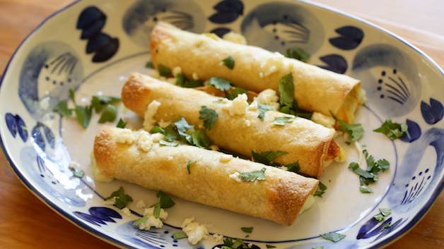 3 cheese and chile taquitos on a blue plate