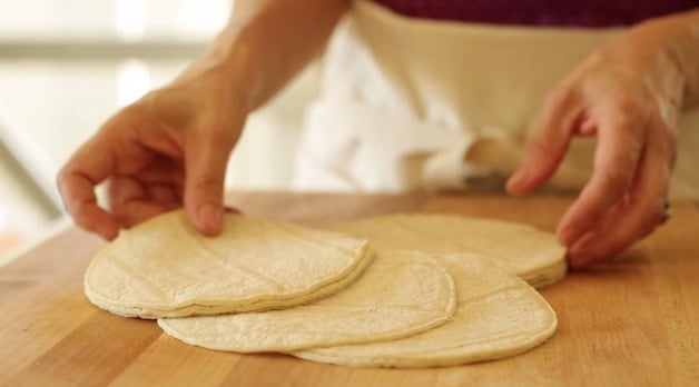 white corn tortillas on a cutting board