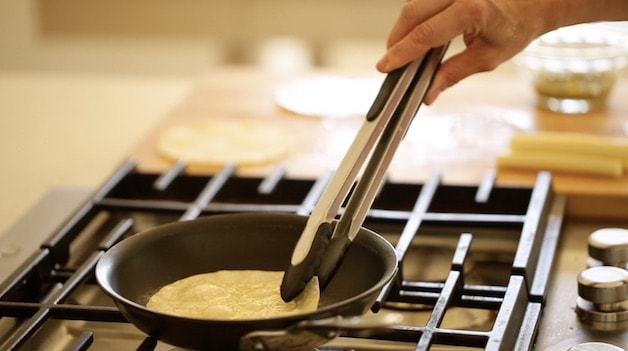 warming corn tortilla in pan