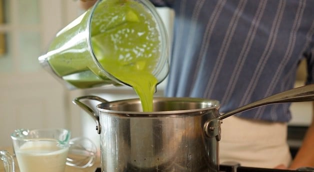 Adding pureed peas from a blender to a sauce pot