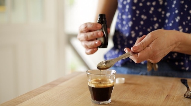 adding rum extract to a glass of espresso