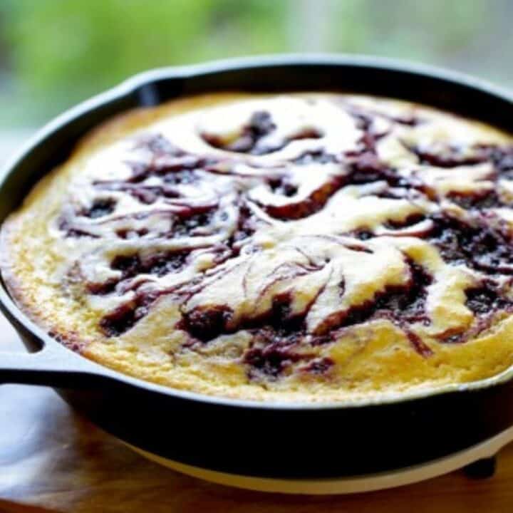 Blackberry Cornbread Cake in a cast-iron skillet