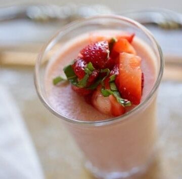 Strawberry Panna Cotta in a clear glass topped with strawberries