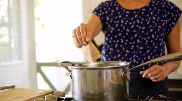 Adding a bag of gelatin to a pot