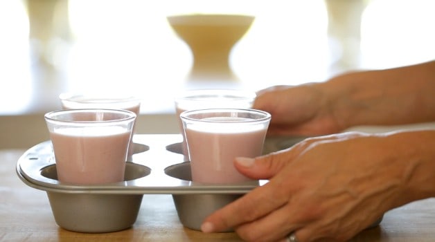 Cups of Strawberry Panna Cotta placed into a jumbo muffin tin and used as a tray