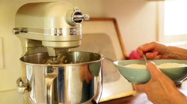 Adding dry ingredients to a cake batter in a stand mixer