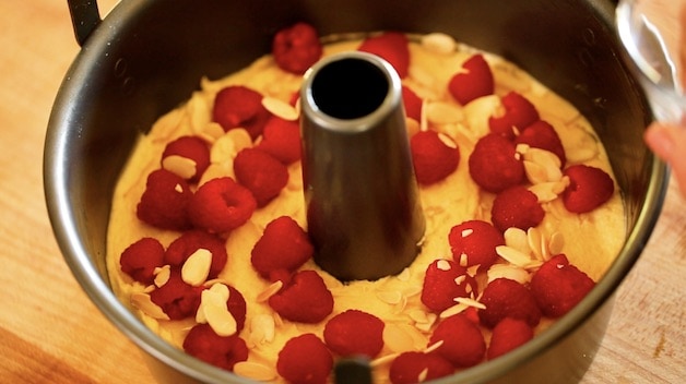 Fresh raspberries and almonds added to cake batter in a angel food cake pan