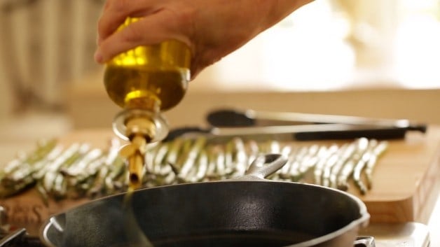 Drizzling oil over a pan 