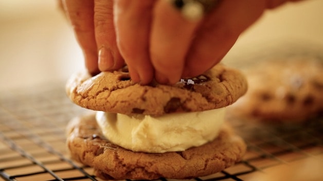 Pressing down a chocolate chip cookie sandwich