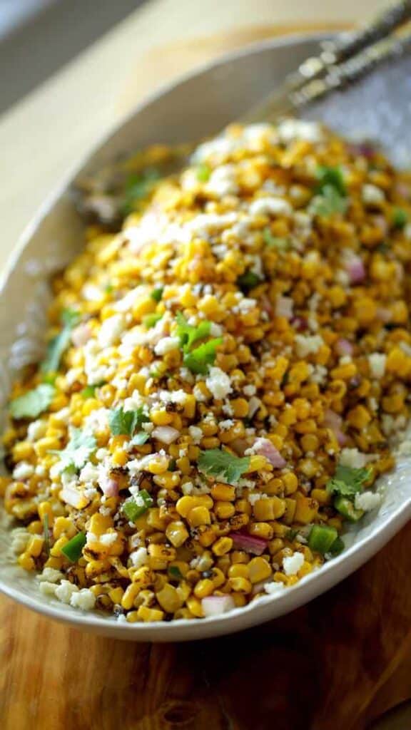 A shallow platter filled with Mexican Corn Salad