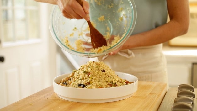 Couscous spooned into white serving bowl