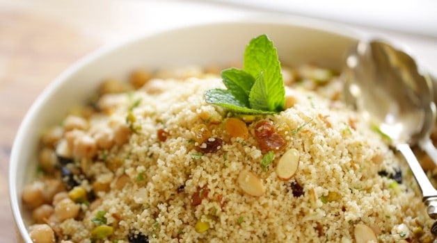 Couscous Salad in white bowl with garnish