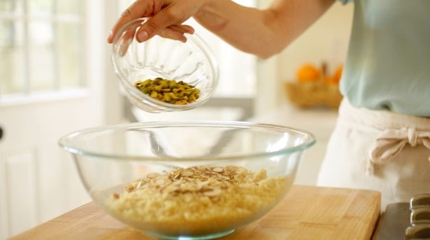 Adding pistachios to couscous for salad