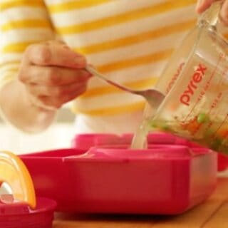 pouring chicken soup into Omie Lunchbox thermos