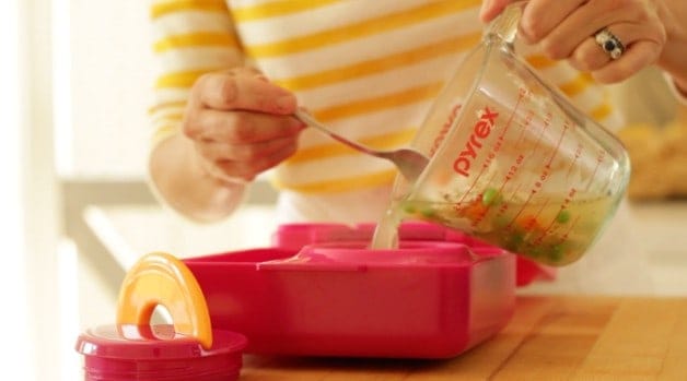 pouring chicken soup into Omie Lunchbox thermos