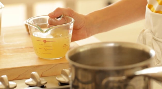 Pyrex pitcher of chicken broth and pot