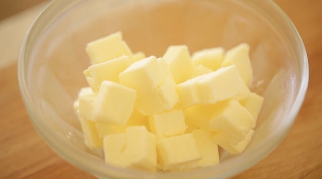 Chilled cubed butter in a glass bowl