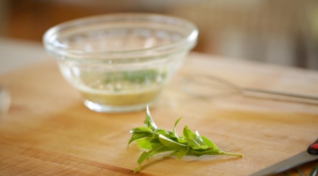 Herbs and dressing on a cutting board
