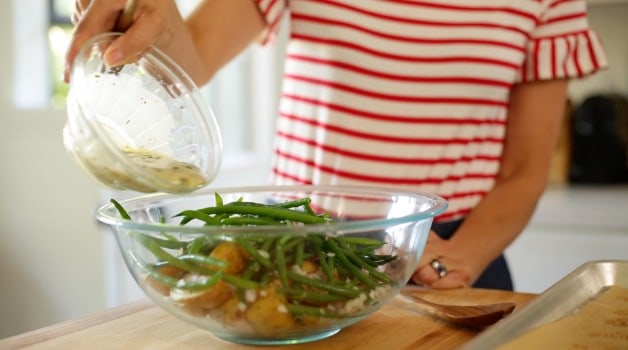 No-Mayo Potato Salad Recipe being mixed together with dressing