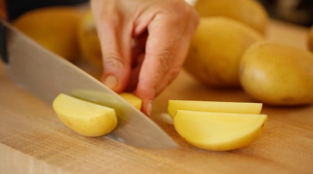 Slicing a potato into wedges