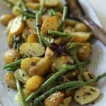 A No-Mayo potato salad on a platter with green beans.
