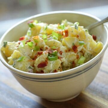 Traditional Potato Salad in a beige bowl with stripe