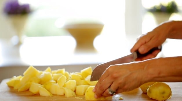 Chopping Golden Yukon Potatoes on cutting board