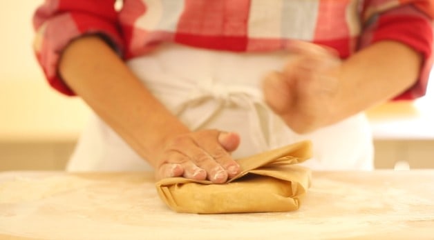 Wrapping dough for Mixing wet ingredients for Cherry Bakewell tart recipe