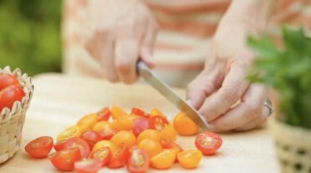 Chopping cherry tomatoes for bruschetta