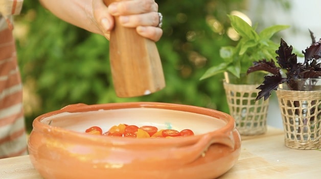 Seasoning chopped tomatoes for bruschetta