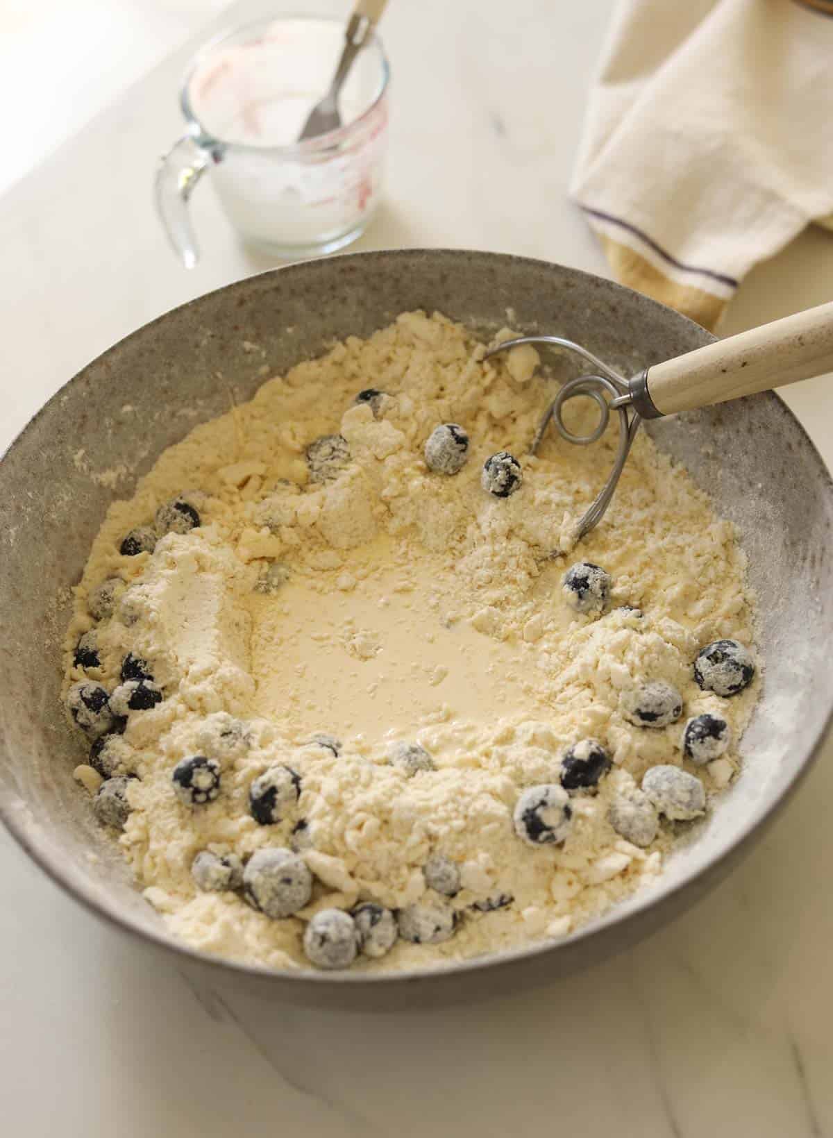 Wet ingredients added to a well created in the butter and flour mixture.