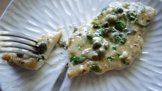 Showing tenderness of chicken with lemon caper sauce