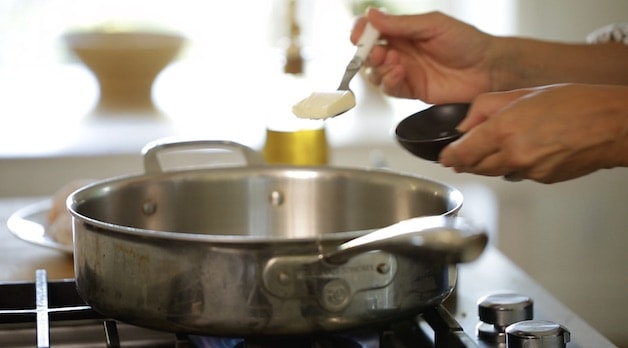 Adding butter to a large skillet