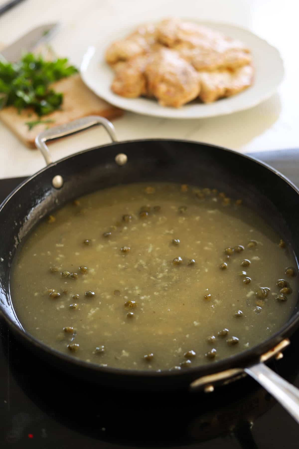 Chicken Piccata sauce in a skillet.