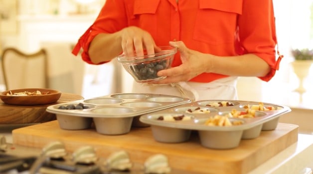 Blueberries Topping oatmeal mixture in muffin tins