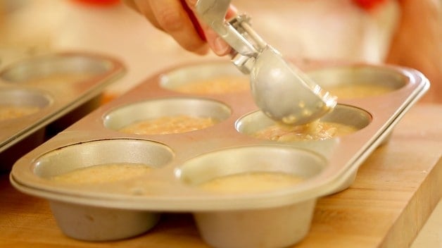 Scooping oatmeal into muffin tins