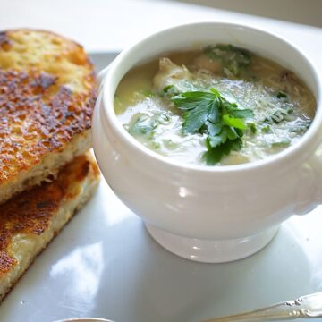 White Bean Soup in a White Bowl and Grilled Cheese Sandwich