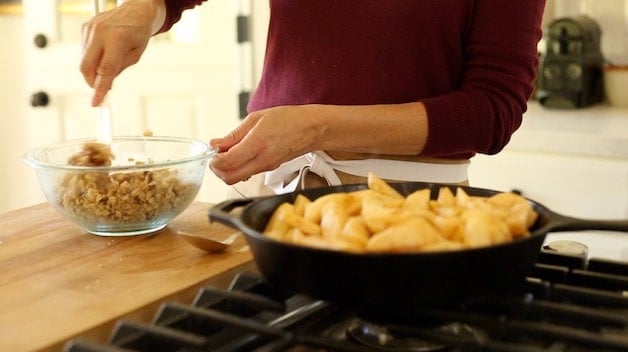 apples simmering in skillet and crumble being made