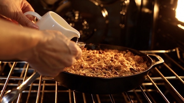 pouring water on an apple crisp