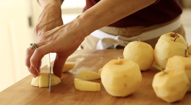 Slicing apples into wedges on a cutting board