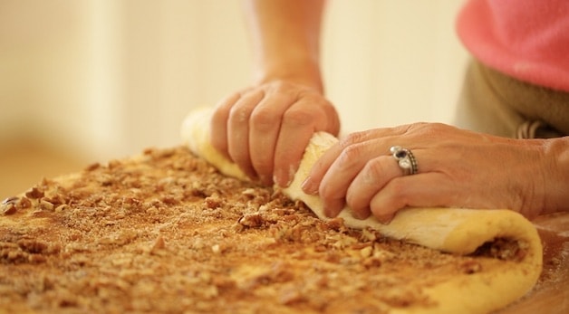 rolling up filling in a pumpkin cinnamon roll loaf