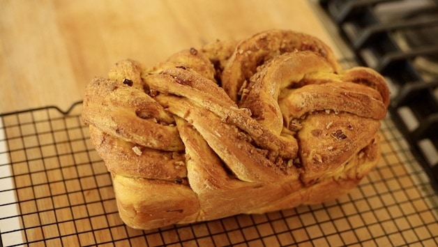 fully baked pumpkin cinnamon roll loaf on a cooling rack