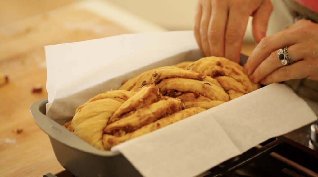 placing bread in a parchment tin