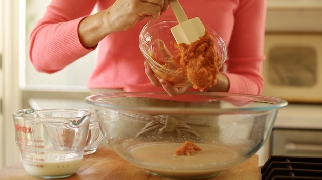 adding pumpkin puree to bowl