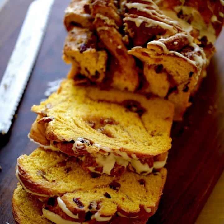 Pumpkin Cinnamon Roll LOaf Sliced open on a board